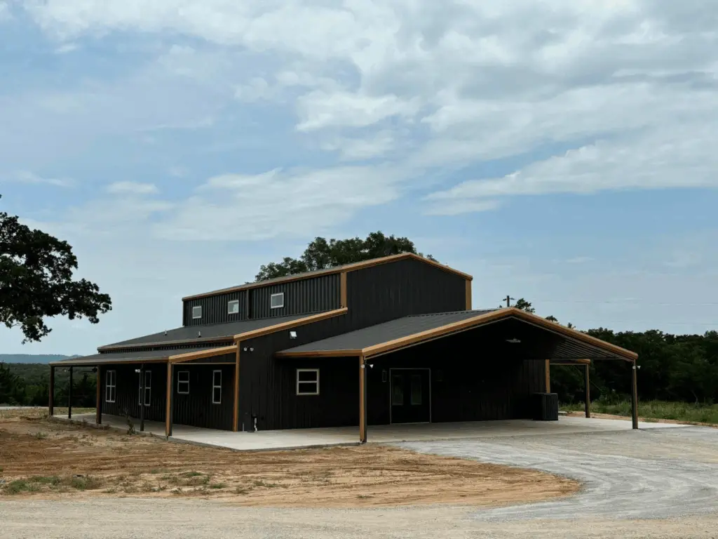 deep green with tan accents barndominium with two porches