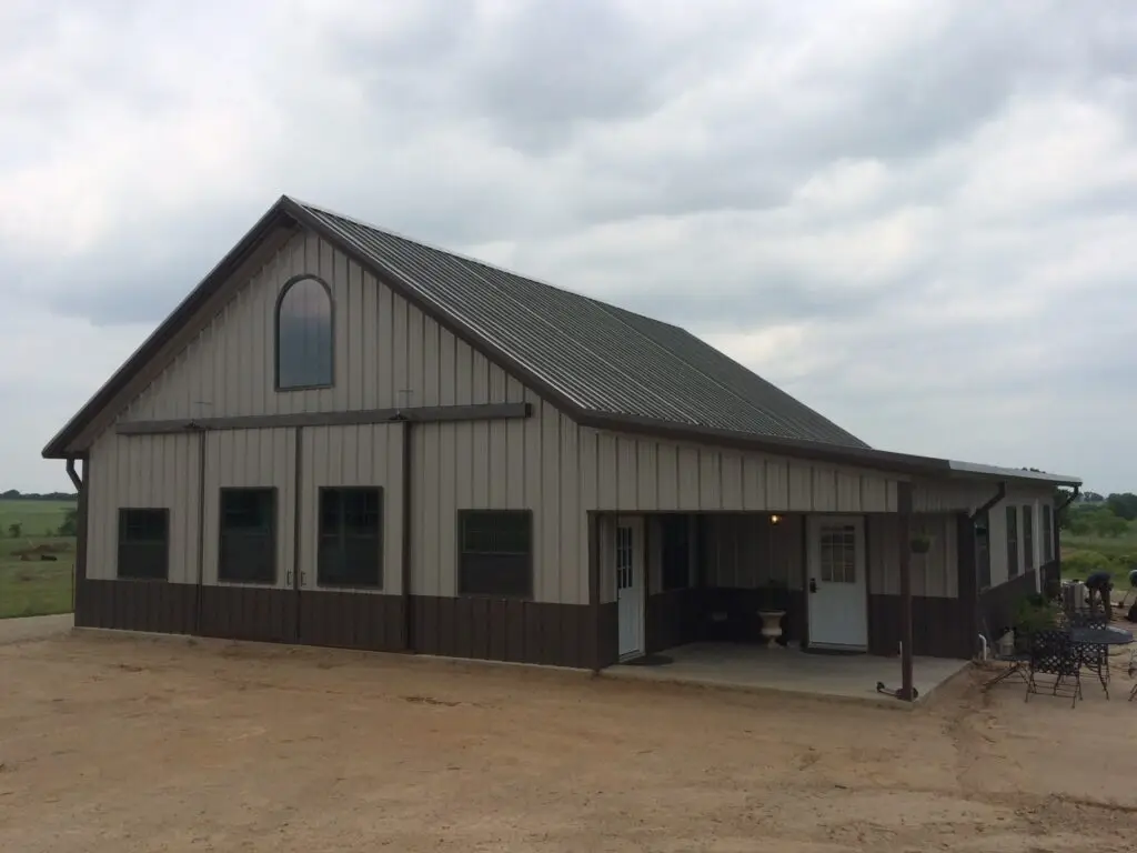 medium and dark tan barndominium with high pitch