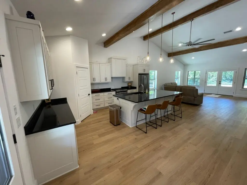 white cabinet kitchen with brown floor