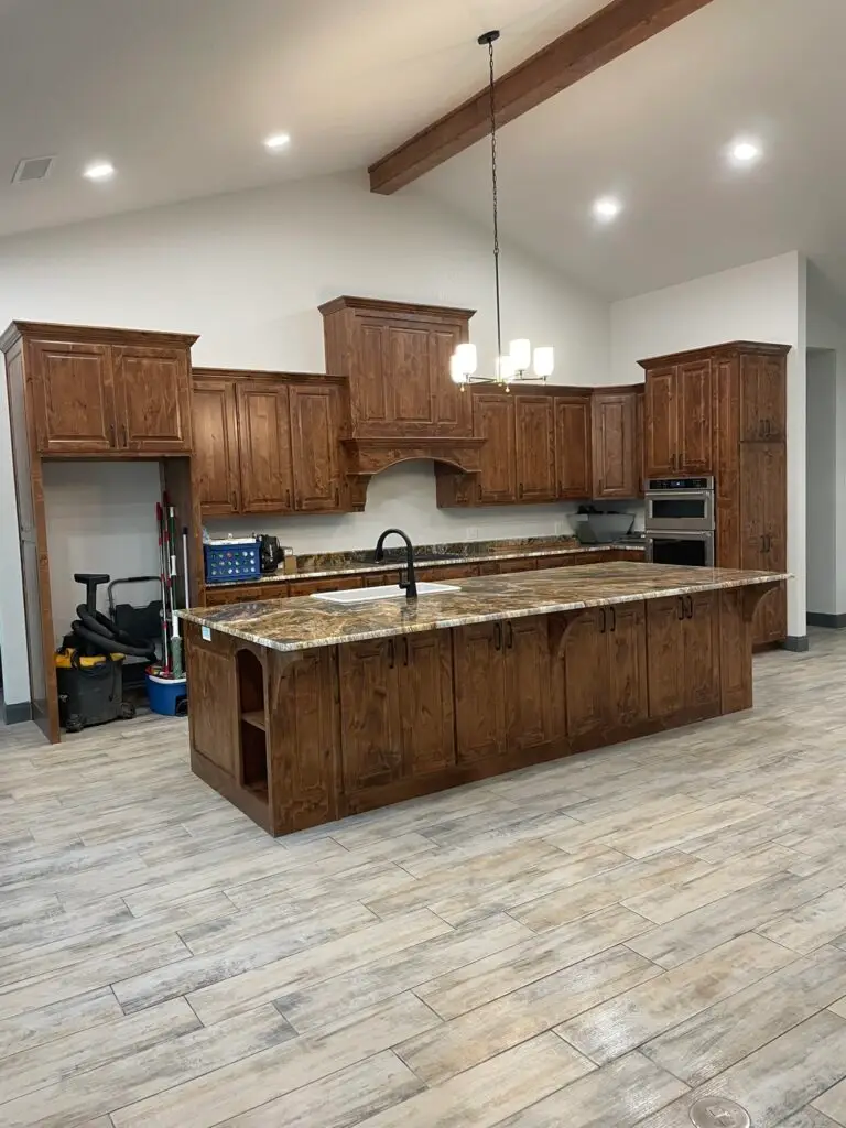 unfinished kitchen with gray flooring and brown cabinets