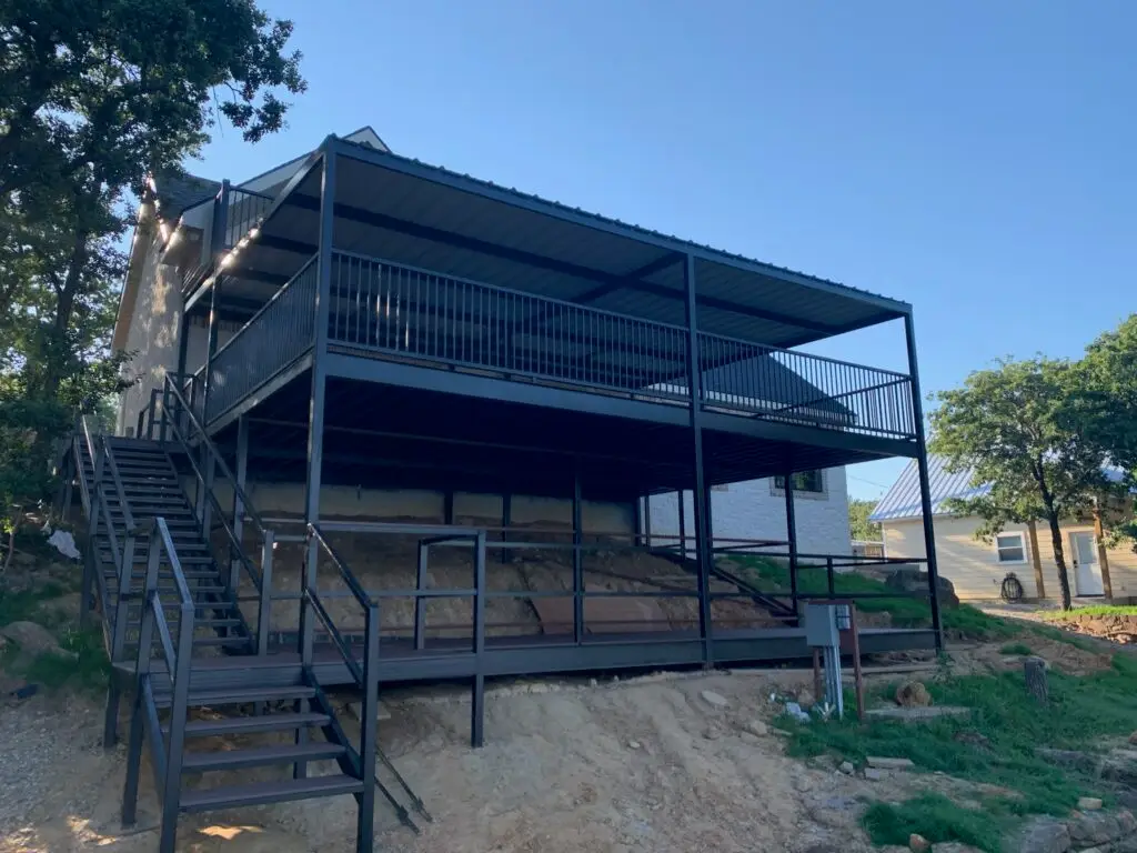 large balcony and porch hanging off a hill attached to a barndo
