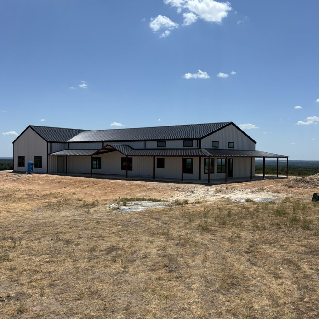 Black and white barndominium with porch